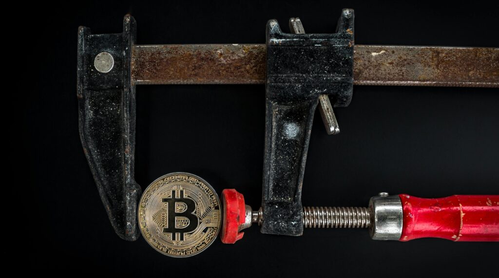 Illustration of a bitcoin attack showing Bitcoin symbol under cyber threat