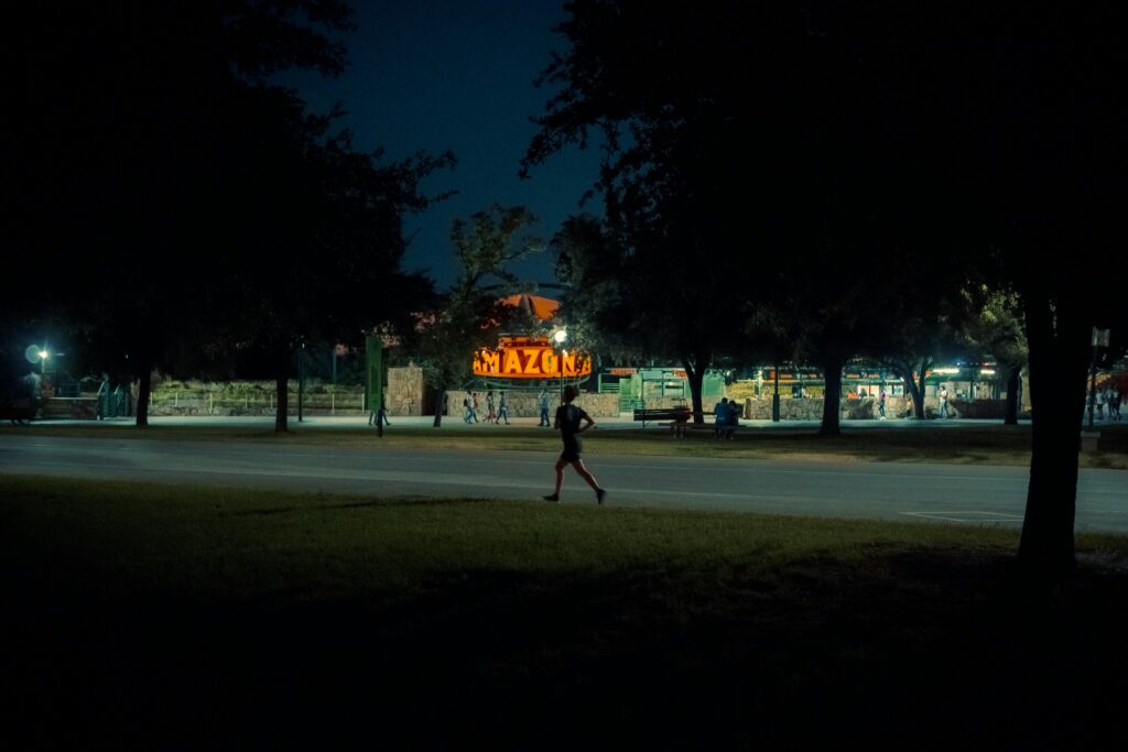 Person jogging at night demonstrating night exercise benefits